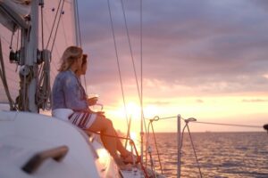 couple-ladies-are-enjoying-their-trip-sailing-boat-while-drinking-wine-watching-beautiful-sunset_613910-3266 Medium